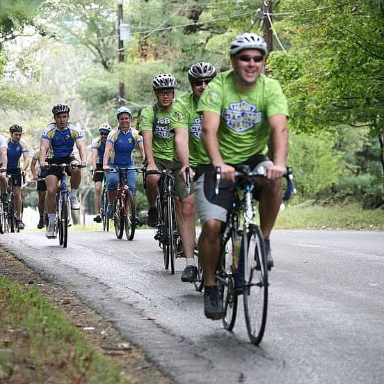 Group of cyclists on bike path in the woods.